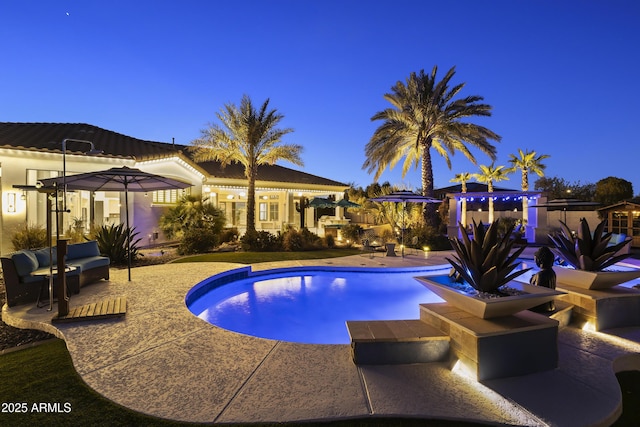 10417 N 180th Dr, Waddell, AZ 85355 - pool at dusk with an outdoor pool and a patio
