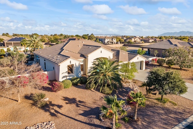 10417 N 180th Dr, Waddell, AZ 85355 - view of front facade featuring a tile roof, stucco siding, a mountain view, a residential view, and driveway