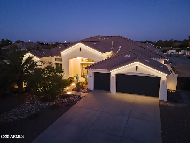 10417 N 180th Dr, Waddell, AZ 85355 - mediterranean / spanish home with a garage, stucco siding, driveway, and a tiled roof