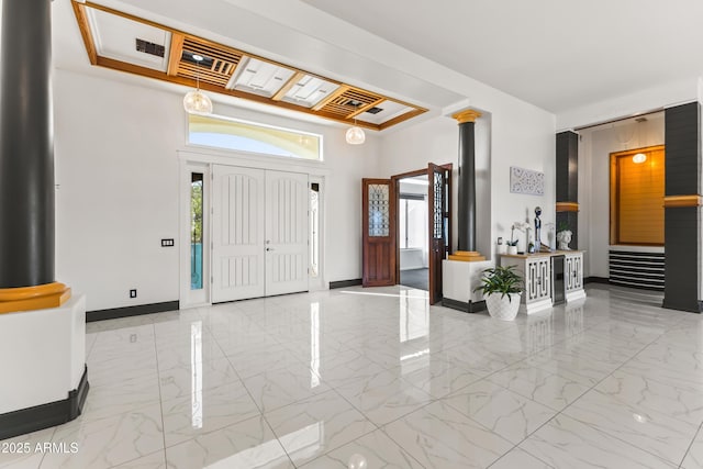 10417 N 180th Dr, Waddell, AZ 85355 - foyer entrance featuring marble finish floor, decorative columns, baseboards, and a raised ceiling