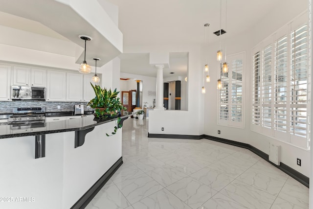 10417 N 180th Dr, Waddell, AZ 85355 - kitchen with appliances with stainless steel finishes, marble finish floor, hanging light fixtures, and a kitchen breakfast bar