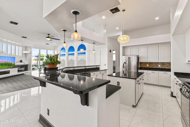 10417 N 180th Dr, Waddell, AZ 85355 - kitchen featuring a spacious island, stainless steel fridge with ice dispenser, marble finish floor, and a kitchen bar