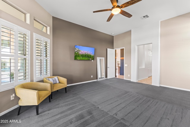 10417 N 180th Dr, Waddell, AZ 85355 - sitting room with visible vents, baseboards, a ceiling fan, a high ceiling, and carpet floors