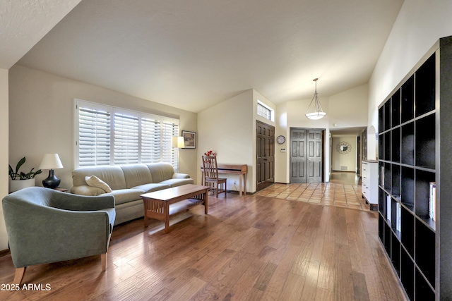 living room with hardwood / wood-style flooring and lofted ceiling