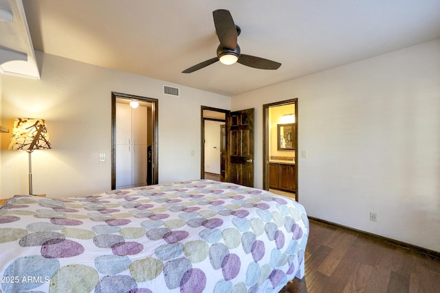 bedroom featuring ceiling fan, dark hardwood / wood-style flooring, and connected bathroom