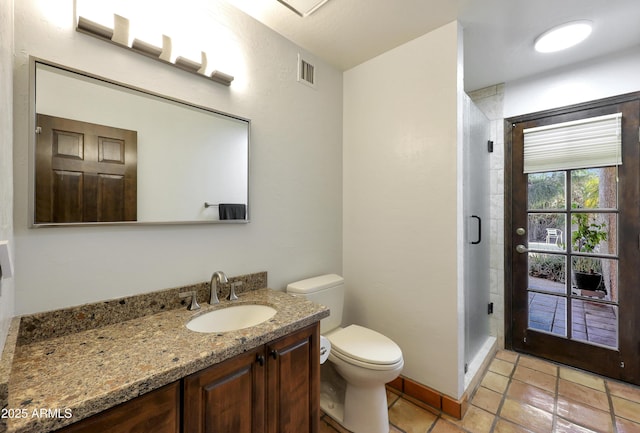 bathroom featuring tile patterned floors, walk in shower, vanity, and toilet