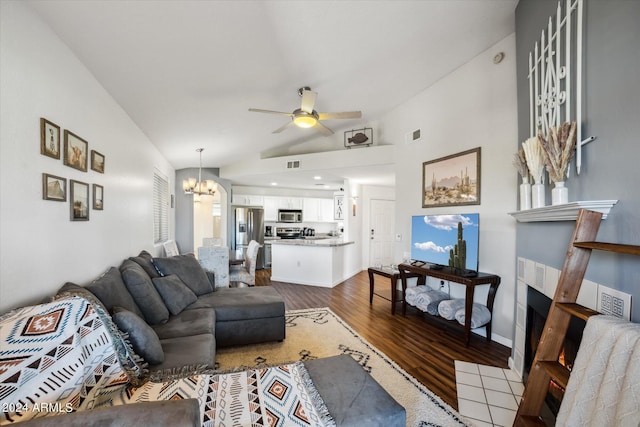 10401 N 52nd St Unit 210, Paradise Valley, AZ 85253 - living room with lofted ceiling, visible vents, dark wood finished floors, and ceiling fan with notable chandelier
