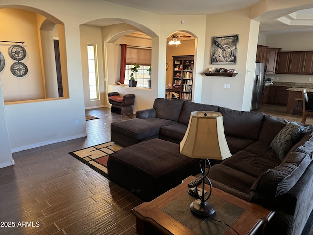 living area with baseboards and dark wood finished floors