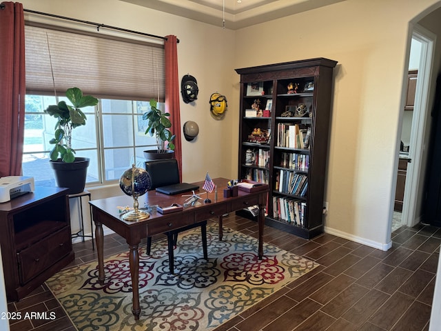 office area featuring arched walkways, baseboards, and wood tiled floor