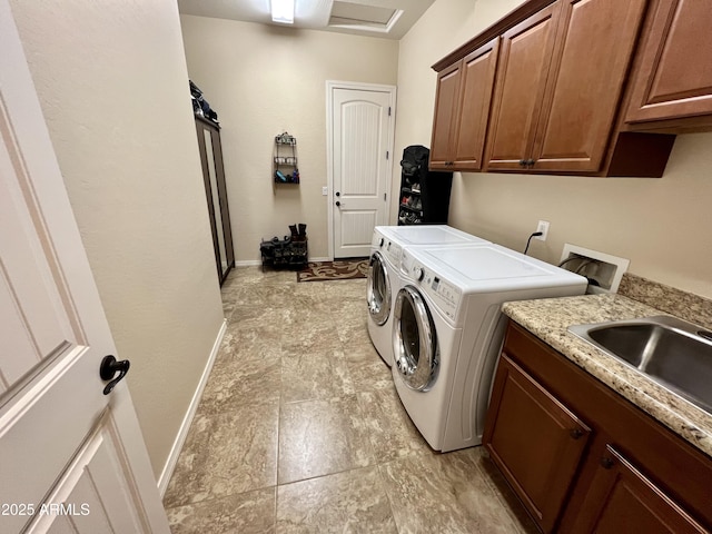 washroom with cabinet space, baseboards, and washing machine and clothes dryer