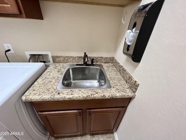 interior details featuring washer hookup and a sink