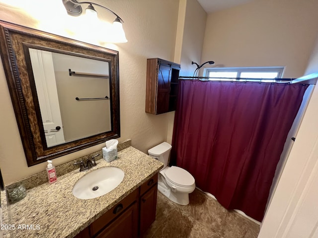 bathroom featuring toilet, a shower with curtain, and vanity