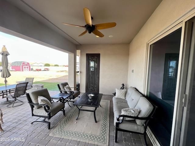 view of patio featuring ceiling fan and outdoor lounge area