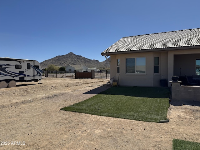 view of yard featuring a mountain view and fence