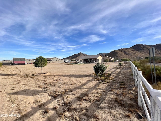 view of yard featuring a mountain view and fence