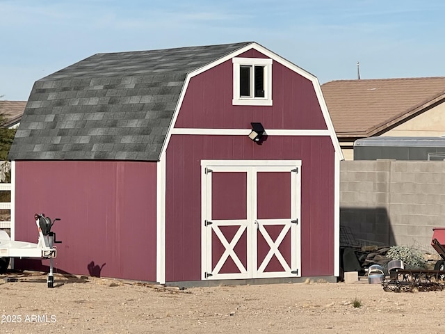 view of outbuilding with an outdoor structure and fence