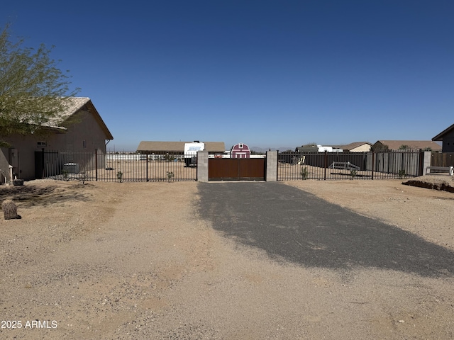 view of yard with central AC unit, a gate, and fence