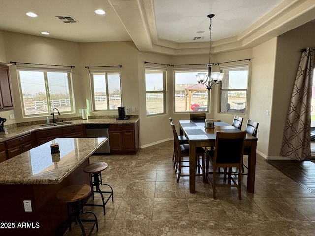 dining space with baseboards, visible vents, and a healthy amount of sunlight