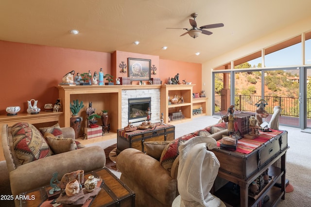 living room with carpet floors, a fireplace, recessed lighting, vaulted ceiling, and ceiling fan