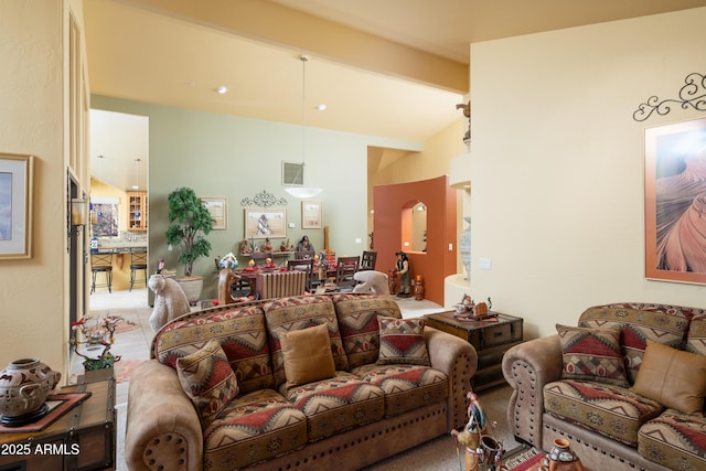 living room with visible vents and lofted ceiling with beams