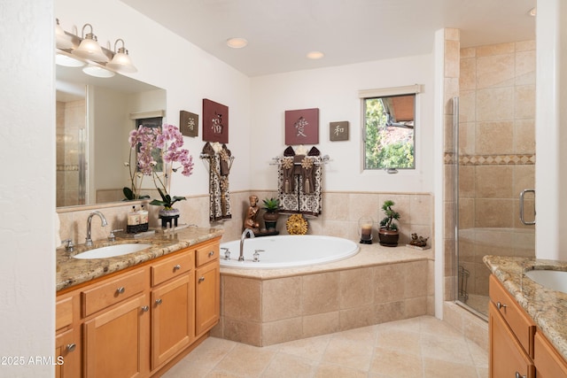 bathroom with a bath, a stall shower, vanity, and tile patterned floors