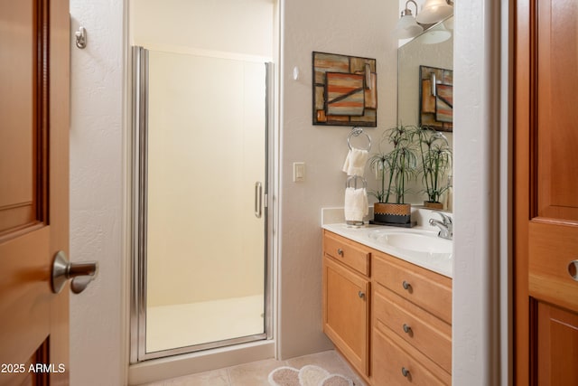 bathroom with a stall shower and vanity