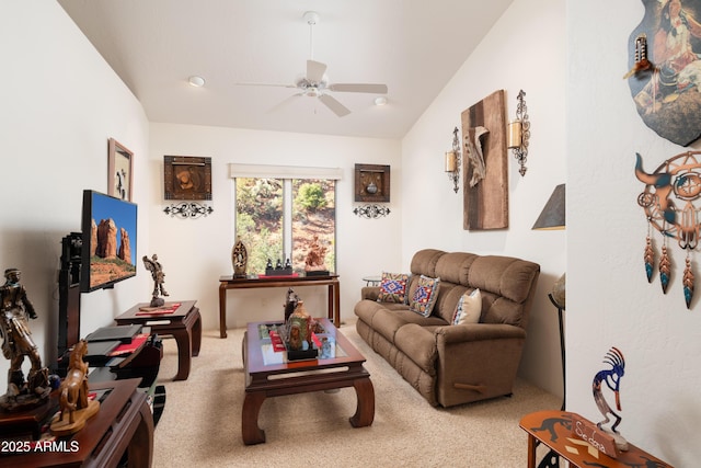 living room featuring carpet floors, a ceiling fan, and lofted ceiling