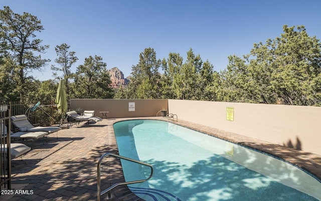 view of swimming pool with a patio area and a fenced in pool