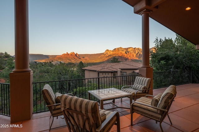 view of patio / terrace with a balcony and a mountain view