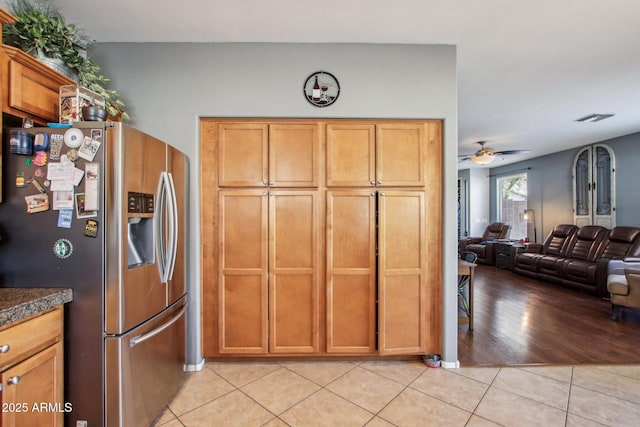 kitchen featuring light tile patterned floors, ceiling fan, and stainless steel refrigerator with ice dispenser