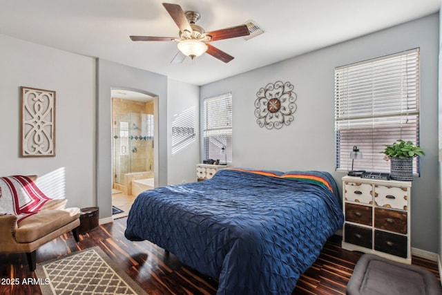 bedroom featuring connected bathroom, hardwood / wood-style floors, and ceiling fan