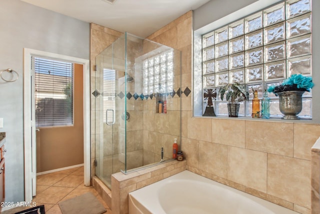 bathroom featuring tile patterned flooring and shower with separate bathtub