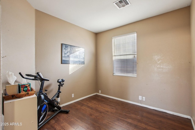 workout area with dark wood-type flooring