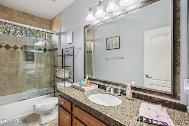 full bathroom with bath / shower combo with glass door, vanity, tile patterned floors, and toilet