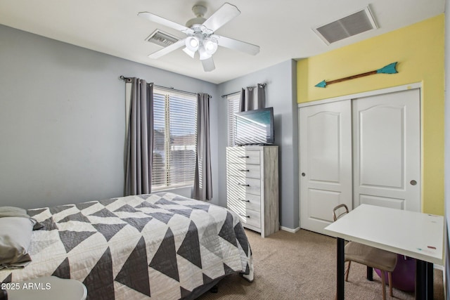 bedroom featuring carpet, ceiling fan, and a closet