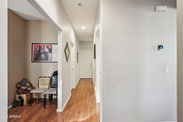 hall with hardwood / wood-style flooring