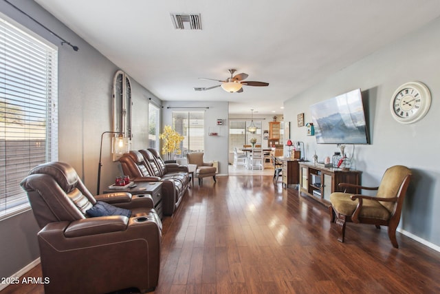 living room with ceiling fan and dark hardwood / wood-style flooring