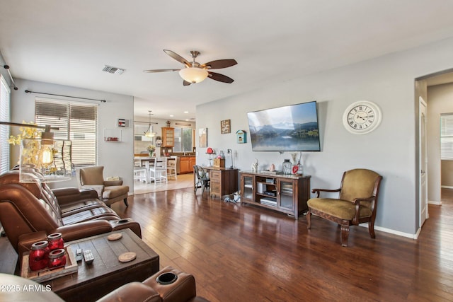 living room featuring dark hardwood / wood-style floors and ceiling fan