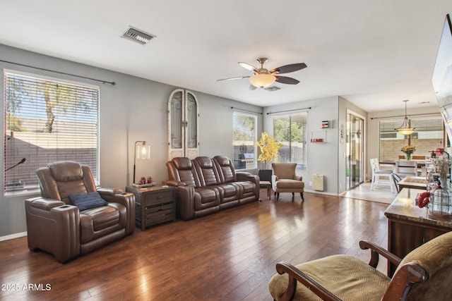 living room featuring dark wood-type flooring and ceiling fan