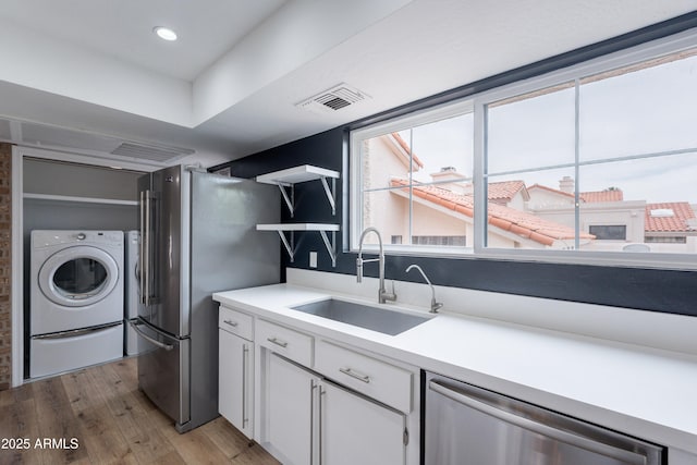 7800 E Lincoln Dr Unit 2029, Scottsdale, AZ 85250 - washroom with washer / dryer and light wood finished floors