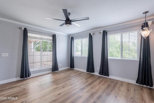 7800 E Lincoln Dr Unit 2029, Scottsdale, AZ 85250 - unfurnished room featuring light wood finished floors, crown molding, baseboards, ceiling fan, and a chandelier