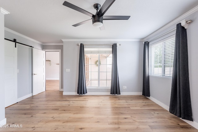 7800 E Lincoln Dr Unit 2029, Scottsdale, AZ 85250 - unfurnished bedroom featuring crown molding, baseboards, light wood finished floors, a barn door, and ceiling fan