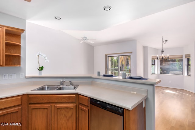 kitchen with light hardwood / wood-style flooring, sink, decorative light fixtures, stainless steel dishwasher, and ceiling fan with notable chandelier