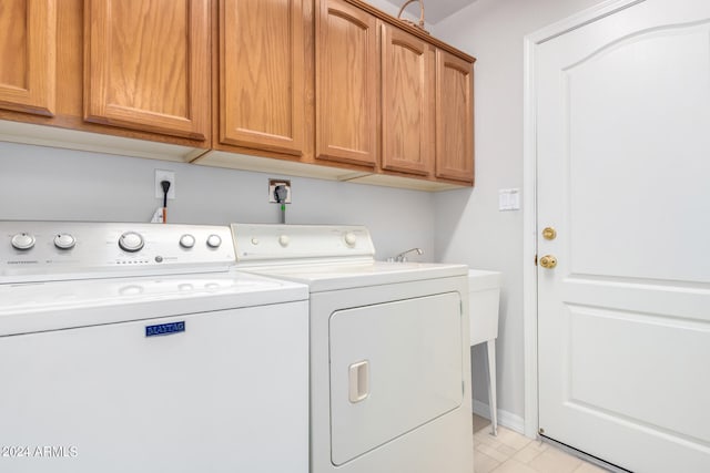 washroom with cabinets and separate washer and dryer