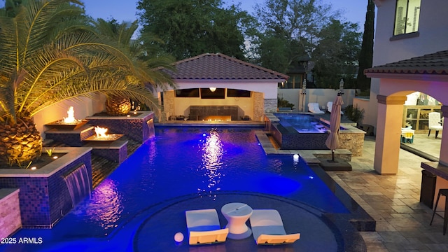 2985 N Point Ridge Rd, Buckeye, AZ 85396 - view of pool featuring a lit fireplace, a pool with connected hot tub, a patio, and an outdoor fire pit