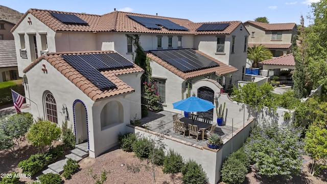 2985 N Point Ridge Rd, Buckeye, AZ 85396 - view of front of property featuring solar panels, stucco siding, a tile roof, a patio, and a fenced backyard