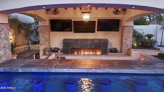 2985 N Point Ridge Rd, Buckeye, AZ 85396 - view of patio / terrace featuring a tile fireplace and an outdoor pool