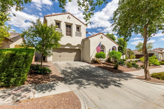 2985 N Point Ridge Rd, Buckeye, AZ 85396 - mediterranean / spanish-style house with a garage, driveway, stucco siding, and a tiled roof