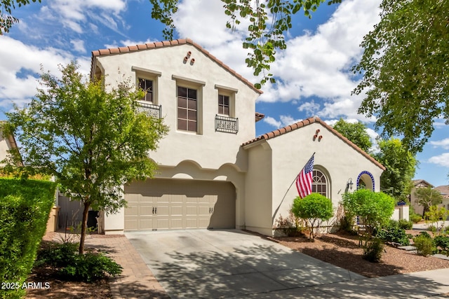2985 N Point Ridge Rd, Buckeye, AZ 85396 - mediterranean / spanish house featuring an attached garage, concrete driveway, stucco siding, and a tiled roof