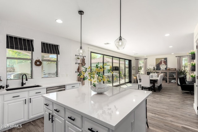 2985 N Point Ridge Rd, Buckeye, AZ 85396 - kitchen featuring a sink, light wood finished floors, light countertops, white cabinetry, and recessed lighting